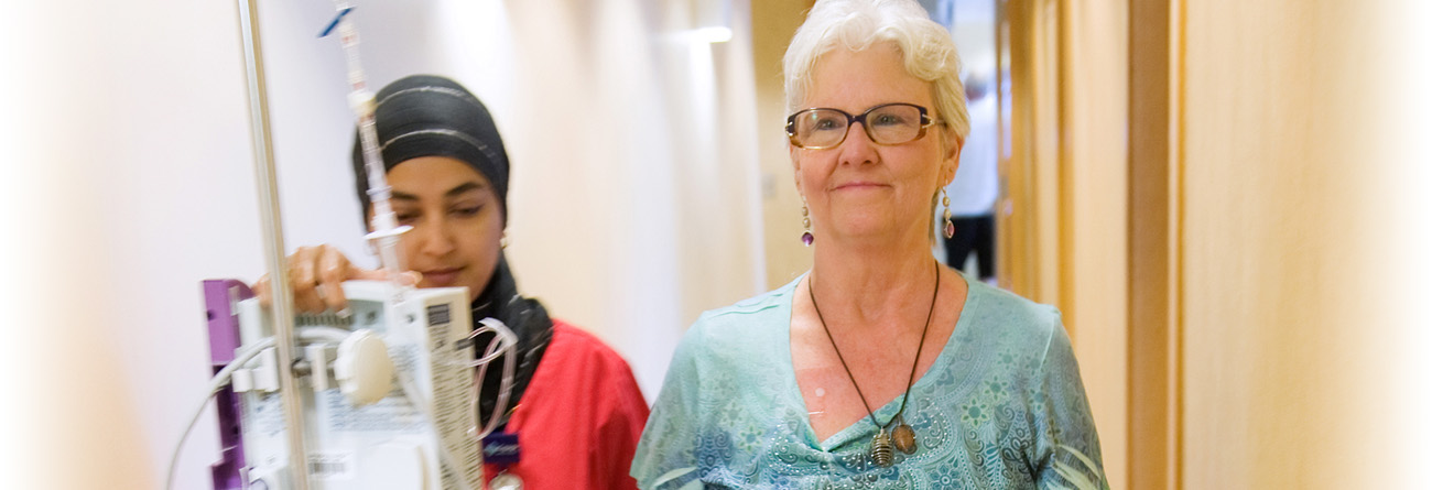 Nurse walking down hall with patient