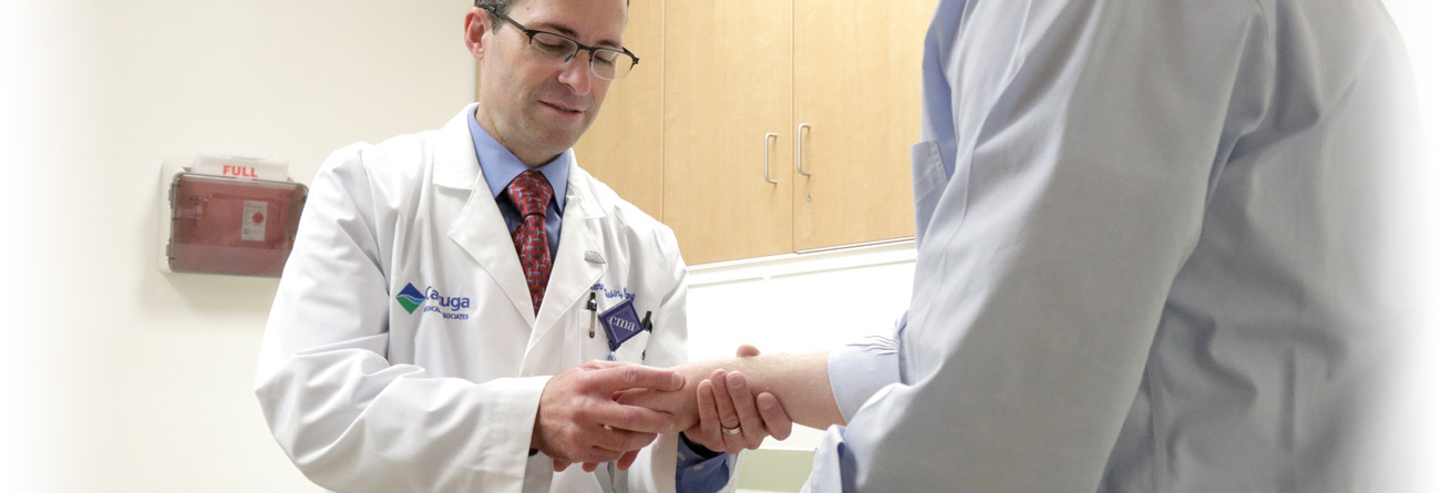 Cayuga Health Occupation Medicine Physician checking patient's wrist