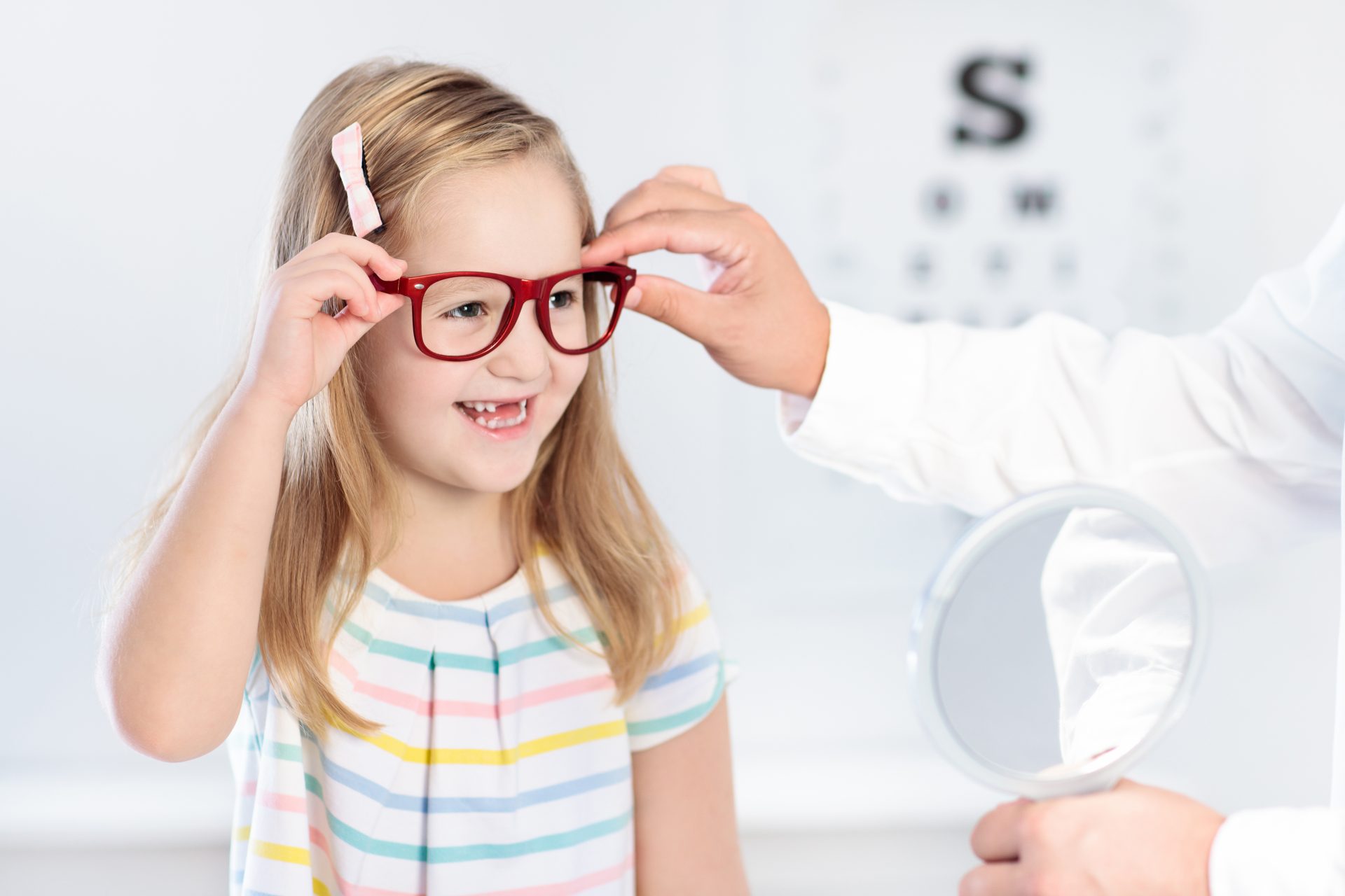 Child At Eye Sight Test. Kid At Optitian. Eyewear For Kids.